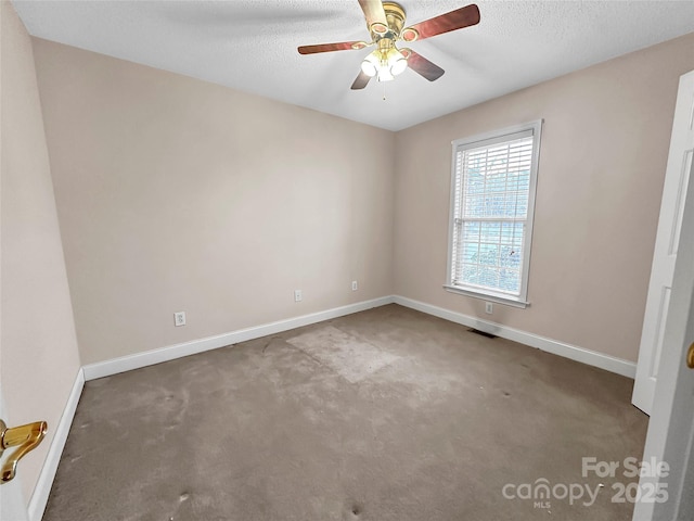 empty room with a textured ceiling, ceiling fan, and carpet flooring