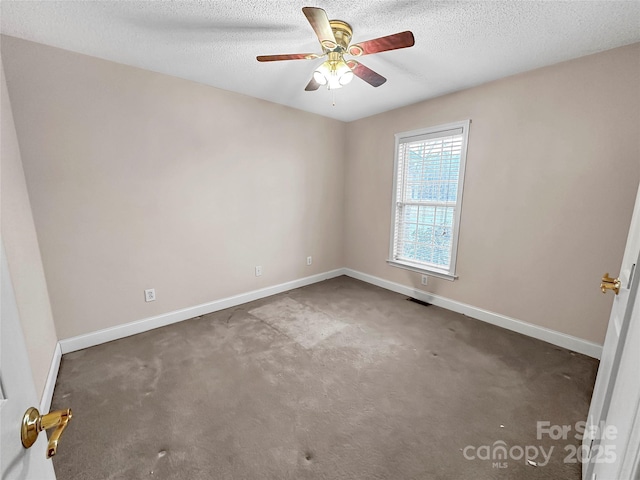 carpeted spare room with ceiling fan and a textured ceiling