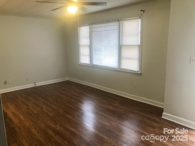 unfurnished room with ceiling fan and dark hardwood / wood-style flooring