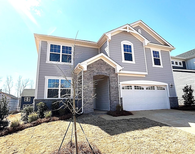 view of front of property featuring a garage, stone siding, and concrete driveway