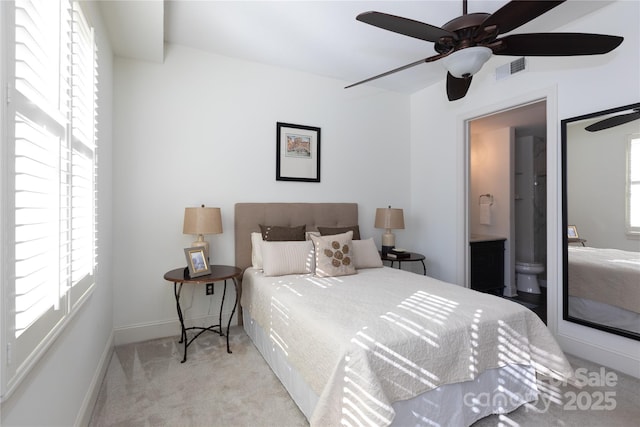 carpeted bedroom featuring ceiling fan and ensuite bath