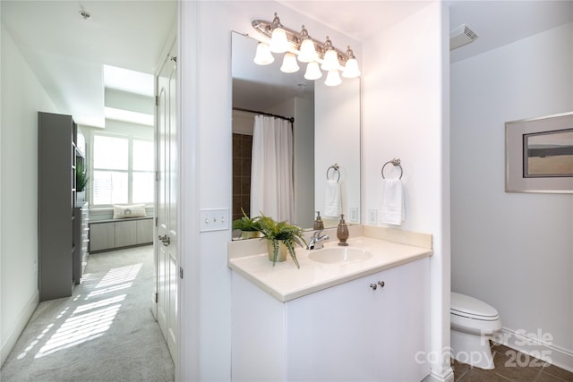 bathroom featuring vanity and toilet