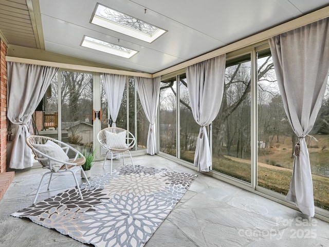 unfurnished sunroom featuring vaulted ceiling with skylight