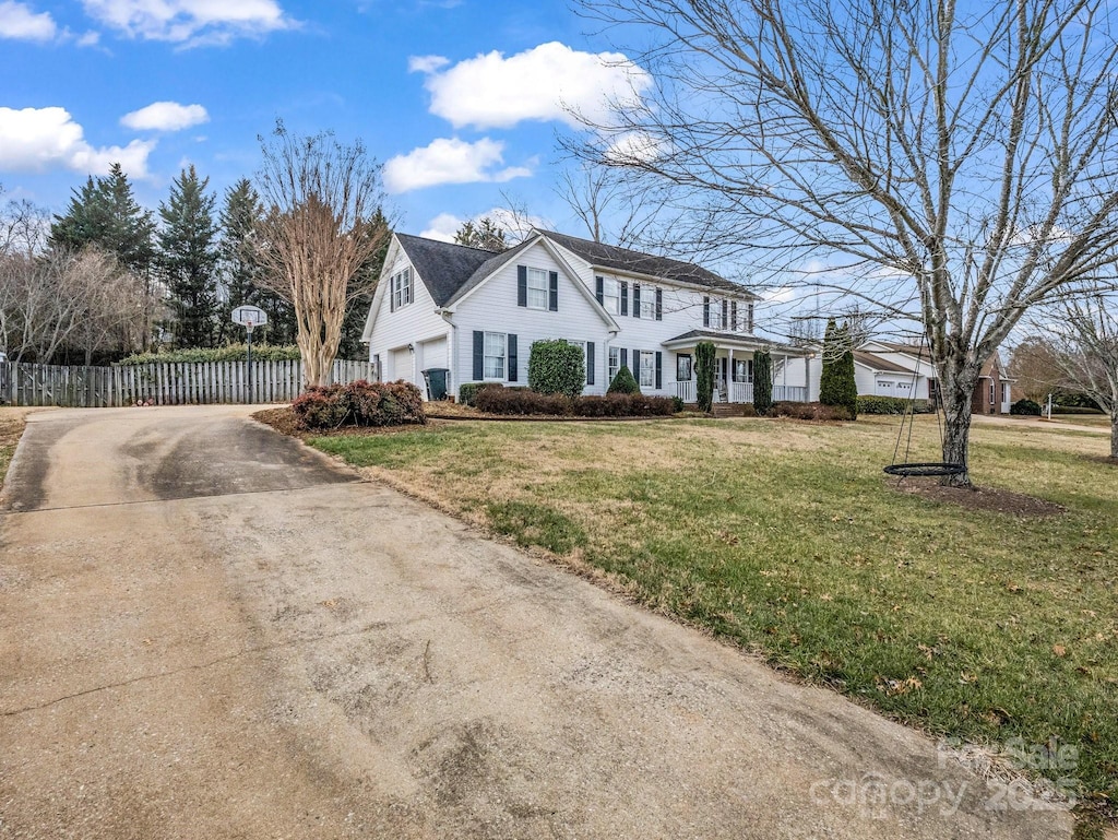 view of front of property with a garage and a front lawn