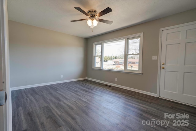 interior space with ceiling fan and dark hardwood / wood-style flooring