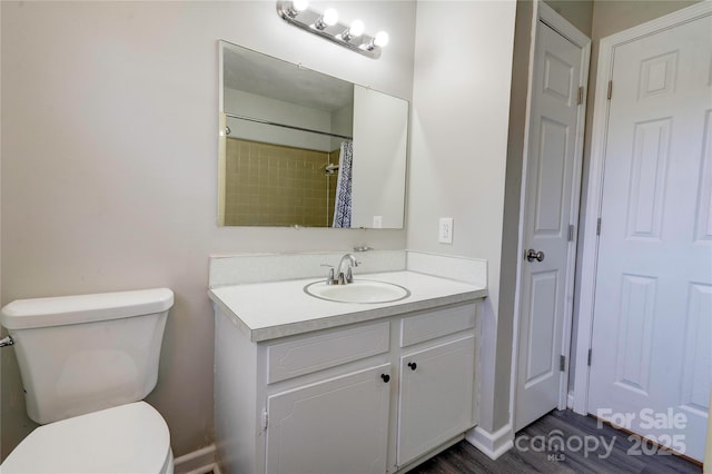 bathroom featuring vanity, hardwood / wood-style floors, curtained shower, and toilet