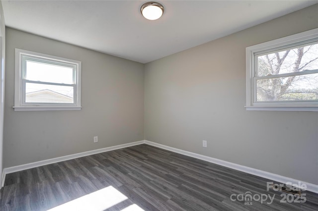 empty room with dark wood-type flooring