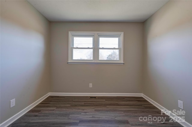 empty room featuring dark hardwood / wood-style floors