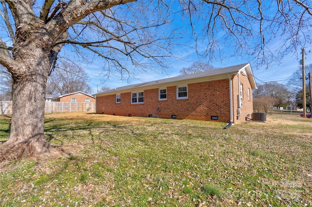 rear view of house featuring a yard and cooling unit