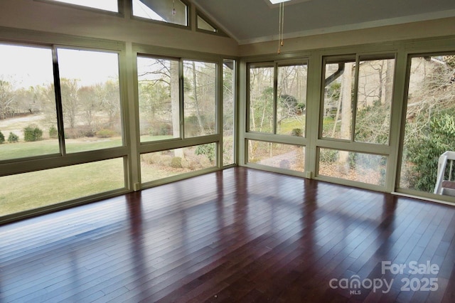 unfurnished sunroom featuring lofted ceiling and a wealth of natural light