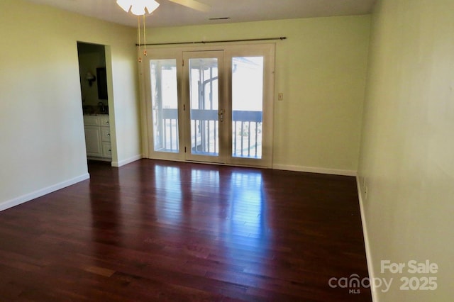 unfurnished room with ceiling fan, dark hardwood / wood-style flooring, and sink