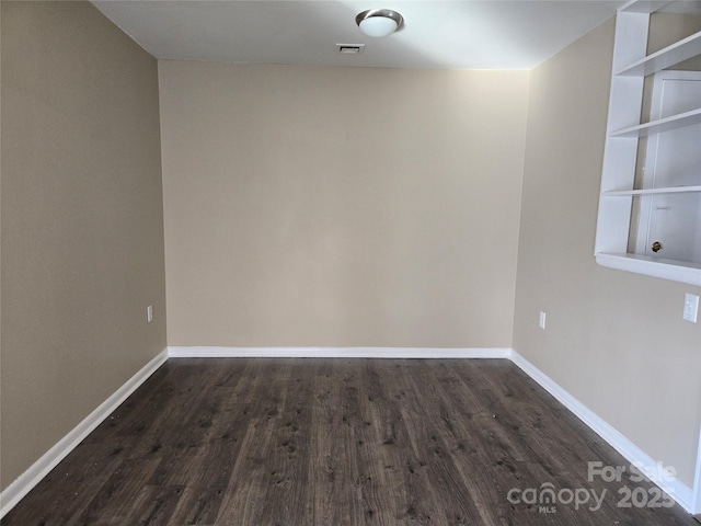 unfurnished room featuring dark hardwood / wood-style flooring