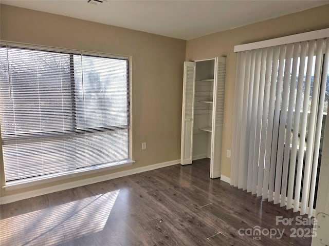 empty room featuring dark hardwood / wood-style flooring