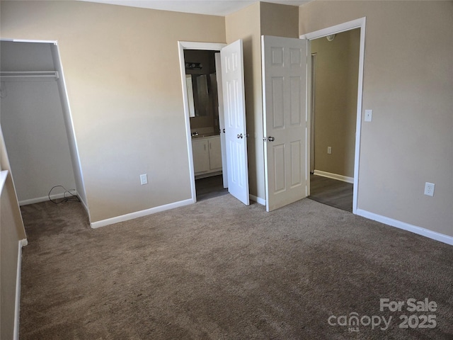 unfurnished bedroom with dark carpet and a closet