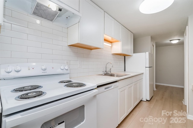 kitchen featuring sink, white appliances, range hood, and white cabinets