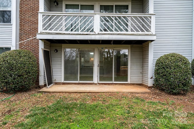 property entrance with a patio and a balcony