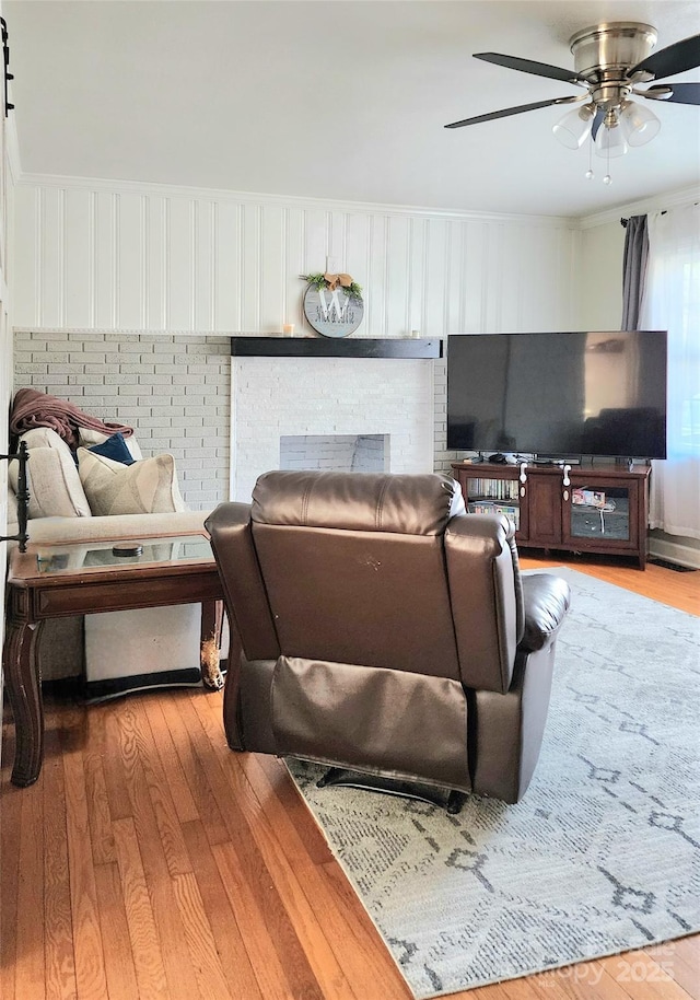 living room with ceiling fan and hardwood / wood-style floors