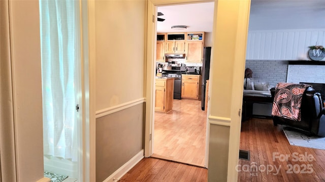 hallway with light hardwood / wood-style flooring