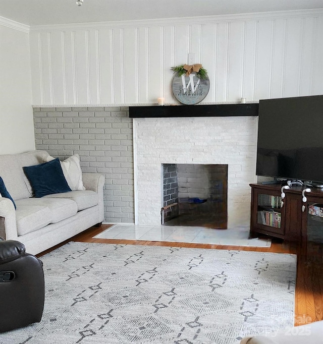 living room with hardwood / wood-style flooring and crown molding