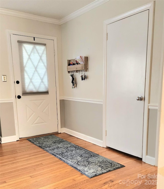 doorway with crown molding and hardwood / wood-style flooring