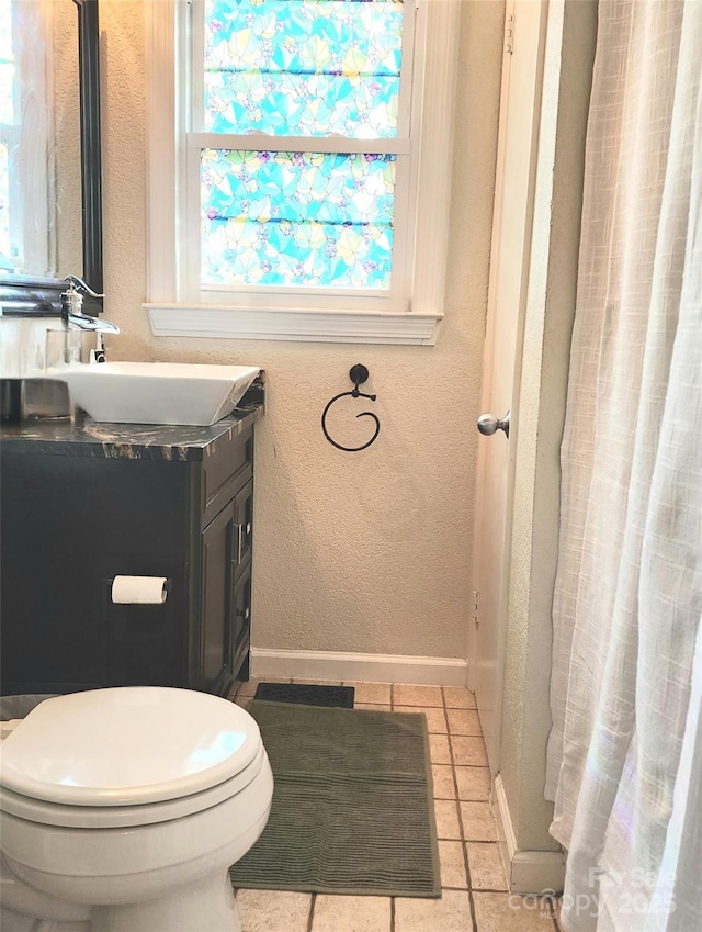 bathroom featuring vanity, tile patterned flooring, and toilet