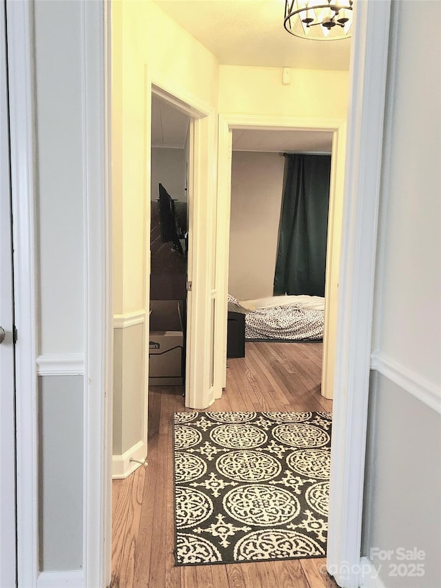 corridor with hardwood / wood-style floors