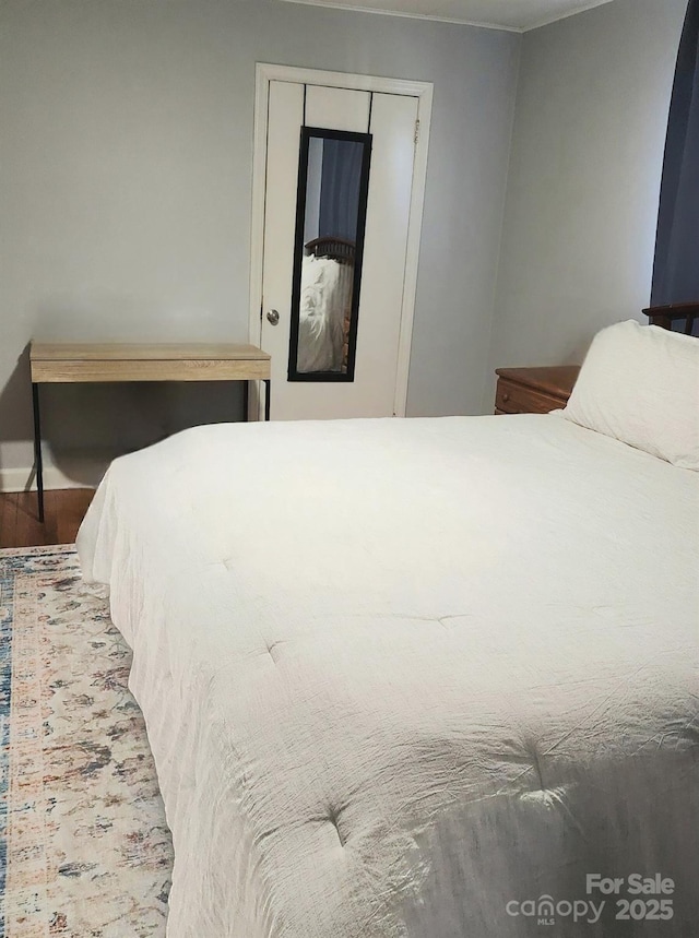 bedroom featuring hardwood / wood-style floors and a closet