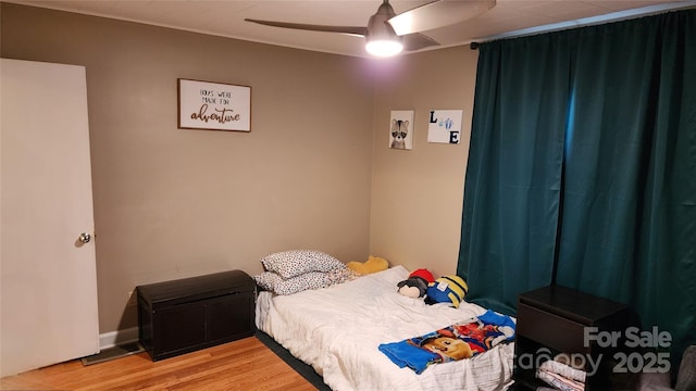 bedroom featuring hardwood / wood-style flooring and ceiling fan