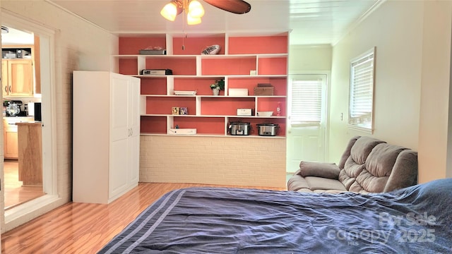 bedroom with crown molding and light wood-type flooring