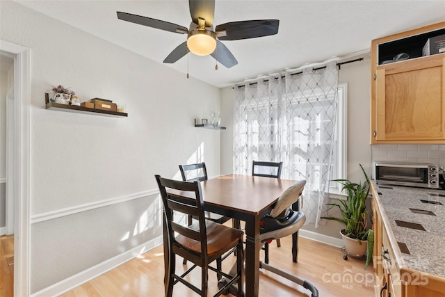 dining room featuring light hardwood / wood-style floors and ceiling fan