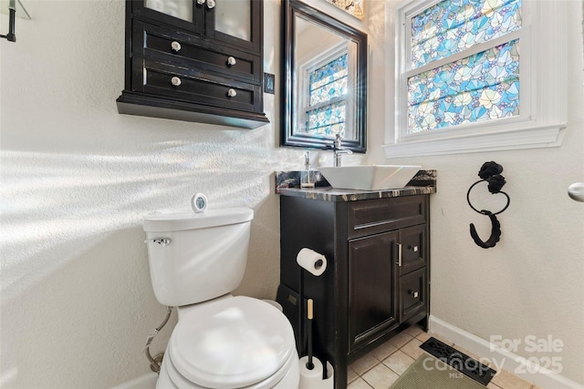 bathroom featuring tile patterned floors, toilet, and vanity