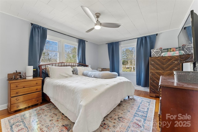 bedroom with ceiling fan and light wood-type flooring