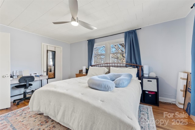 bedroom with ceiling fan and wood-type flooring