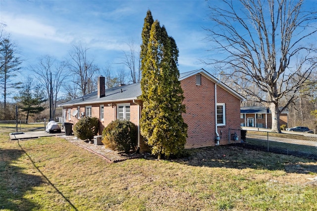 view of side of home featuring a lawn