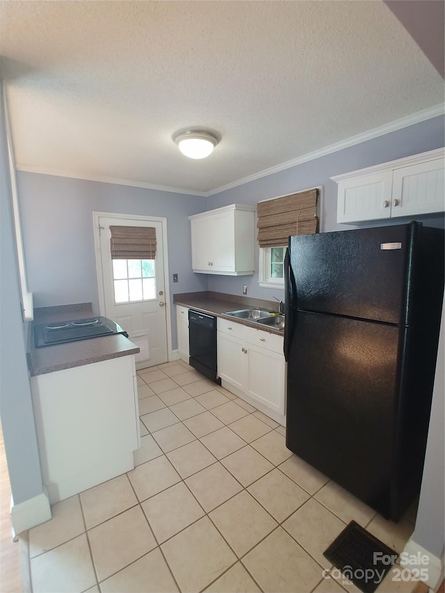 kitchen with light tile patterned flooring, white cabinetry, a textured ceiling, ornamental molding, and black appliances