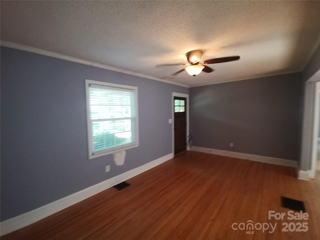 unfurnished room with ceiling fan, ornamental molding, hardwood / wood-style floors, and a textured ceiling