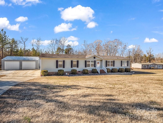 ranch-style house with an outbuilding, a garage, and a front yard