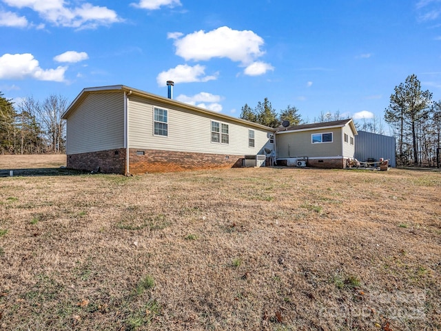 back of property featuring a yard