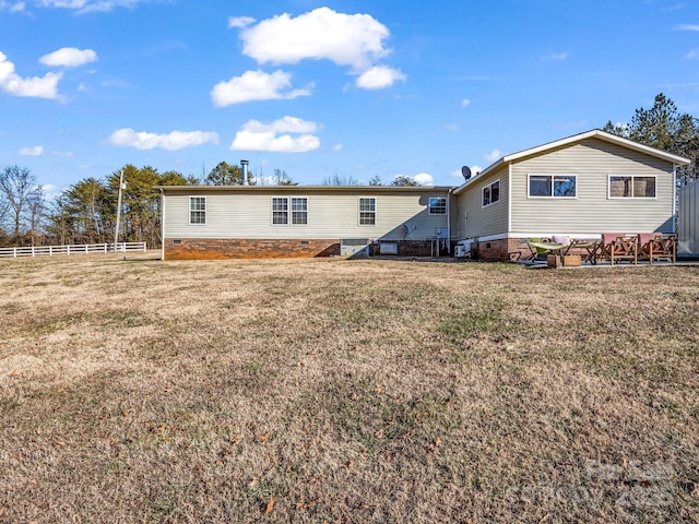 back of property featuring a lawn