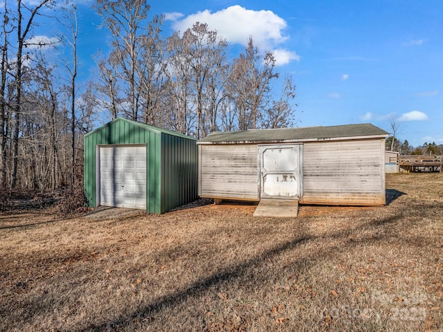 view of outbuilding featuring a garage and a yard