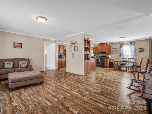 living room with ornamental molding, wood-type flooring, and a textured ceiling