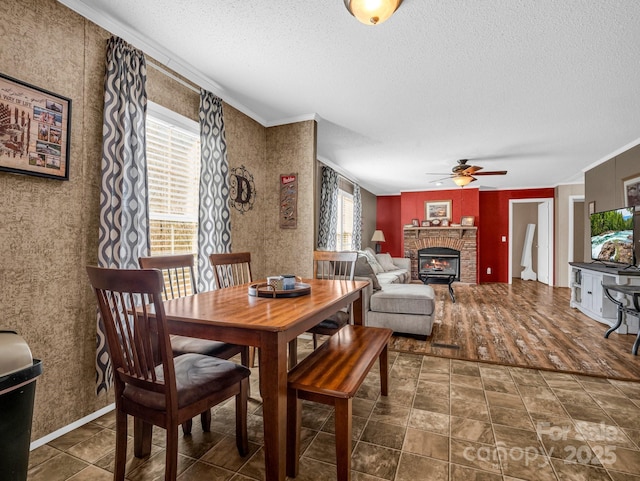 dining area featuring crown molding, ceiling fan, and a textured ceiling