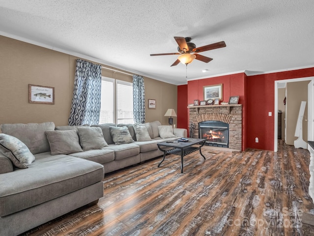 living room with dark hardwood / wood-style flooring, ceiling fan, a fireplace, and a textured ceiling