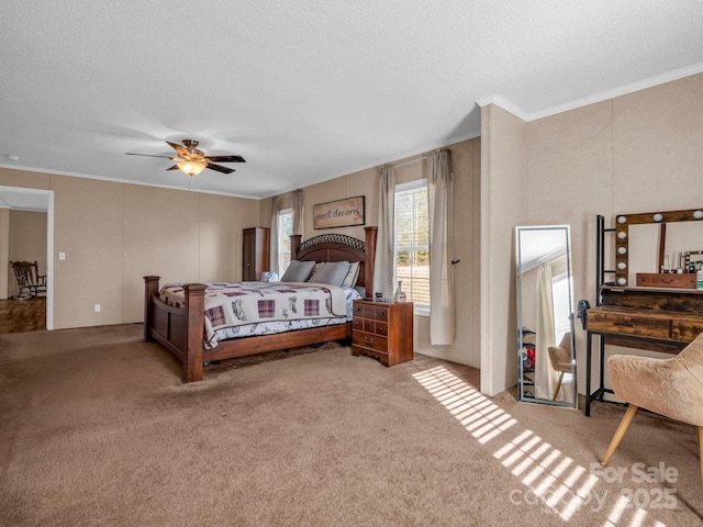 carpeted bedroom with crown molding, a textured ceiling, and ceiling fan