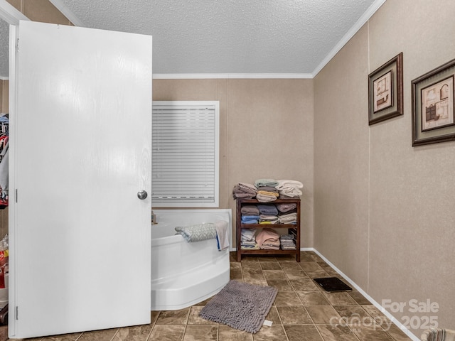 bathroom with ornamental molding and a textured ceiling