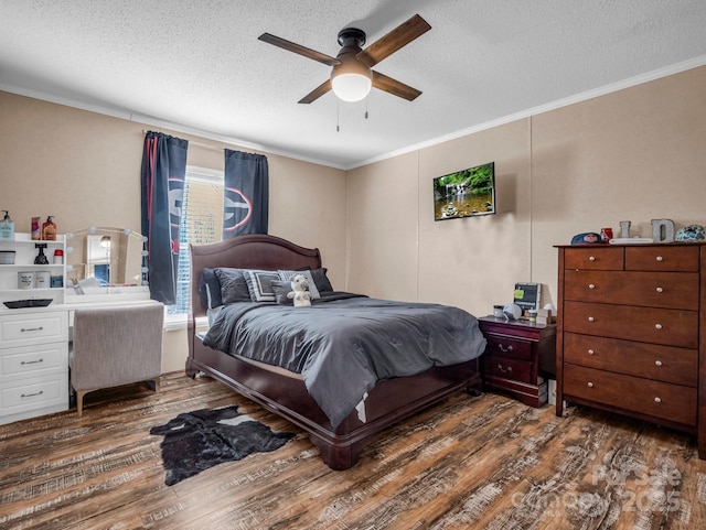 bedroom with crown molding, a textured ceiling, dark wood-type flooring, and ceiling fan