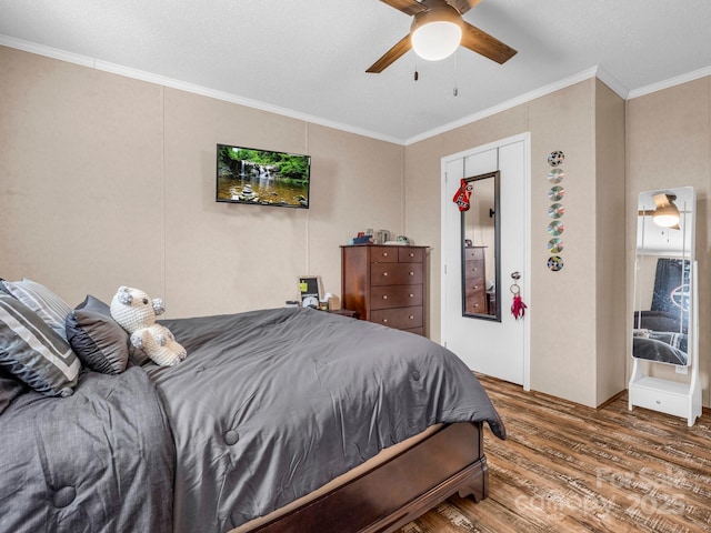 bedroom featuring crown molding, wood-type flooring, and ceiling fan