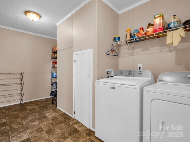 washroom with a textured ceiling, ornamental molding, and washing machine and clothes dryer