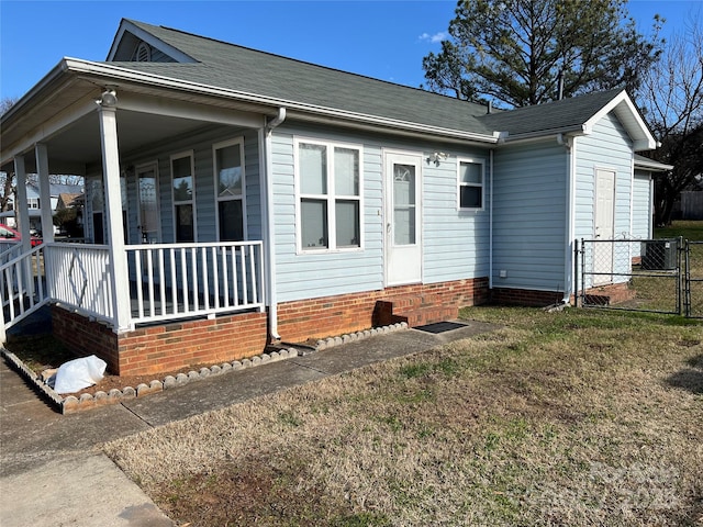 view of home's exterior featuring cooling unit and a porch