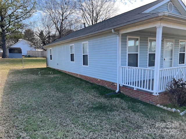 view of side of home with a yard